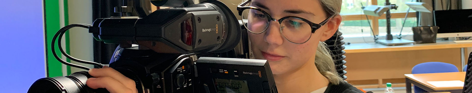 Image of female student holding a video camera
