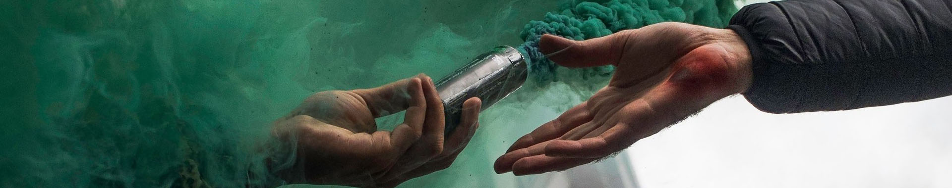 image of two hands one holding a cannister of smoke